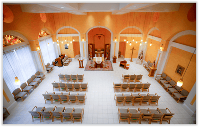 Spacious interior of a chapel with seating.