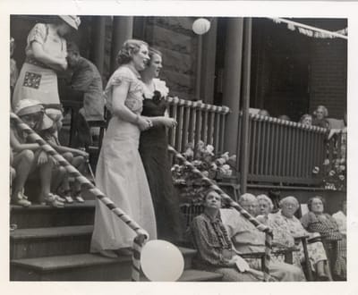 Residents enjoying an outdoor celebration in old-fashioned attire.