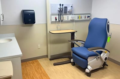 Comfortable patient room with a blue chair