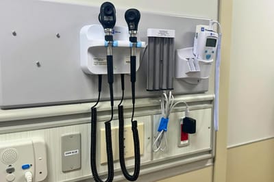 Medical equipment on a wall in a care facility room.