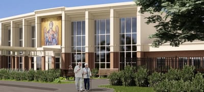 Two residents walking by the facility's exterior.