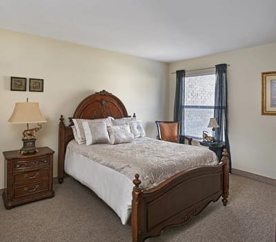 Cozy bedroom with antique furniture and a window