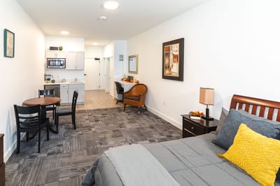 Bright interior of a resident room with kitchenette