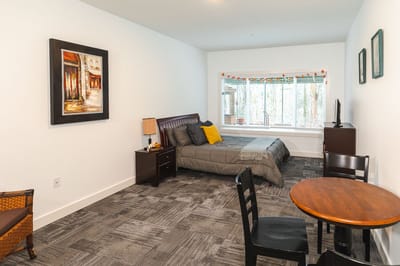 Private resident room with bed and seating area