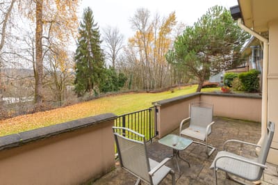 Outdoor patio area with seating and landscaped view