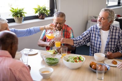 Residents enjoying a meal together in the dining room