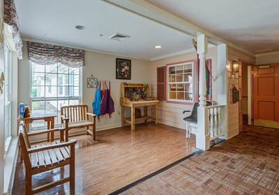 Bright common area with seating and arts & crafts station