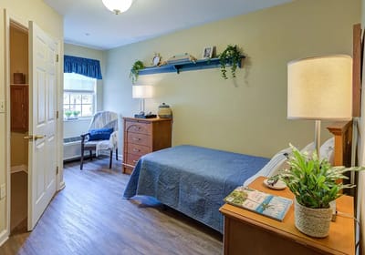 Cozy private resident room with a bed and furniture