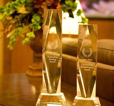Two awards displayed on a table
