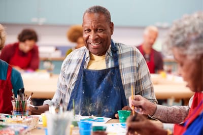 Residents participating in an art activity in a creative space