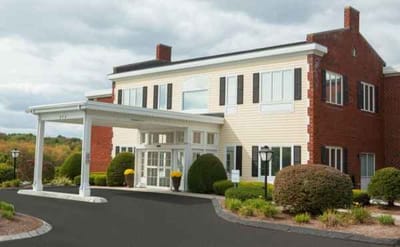 Pioneer Valley Living and Rehab, nursing home in Sioux City, IA — Entrance of a senior living facility with landscaping
