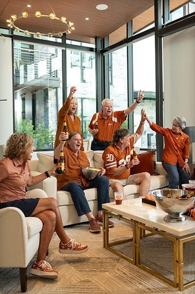 Residents celebrating in a common area during a game