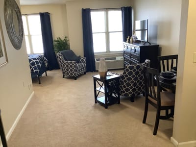 A cozy and well-furnished resident room in a senior living facility