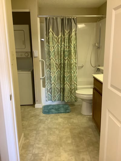 A clean bathroom area with laundry facilities