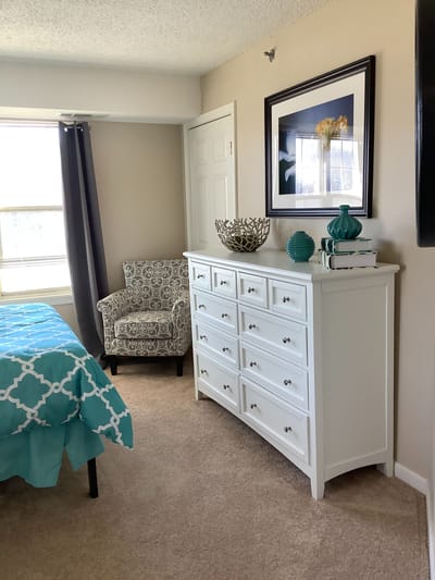 Cozy resident room with chair and dresser