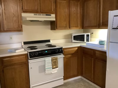 A kitchen area with appliances and cabinets