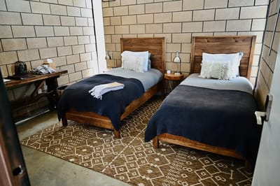 Cozy twin bedroom setup with wooden furniture