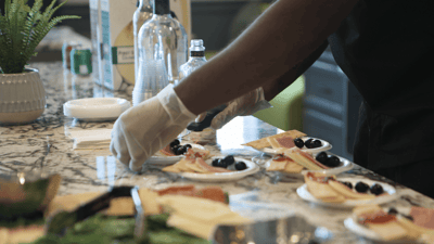 Staff preparing plates with food in a common area