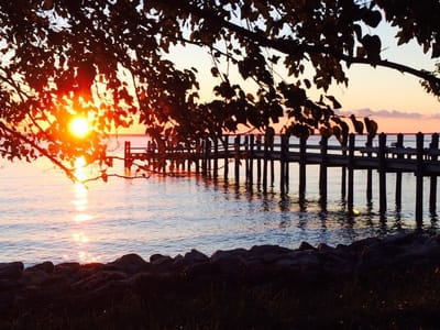 Sunset view over a calm waterfront pier