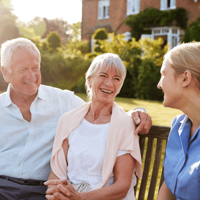 Residents and staff enjoying a conversation outdoors