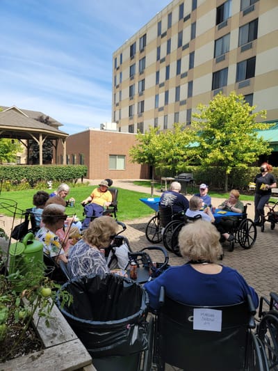 Residents enjoying a sunny day in the facility garden