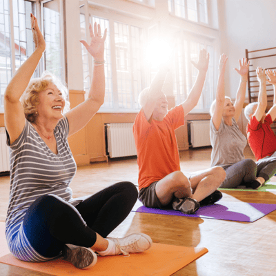 Seniors participating in a seated exercise class