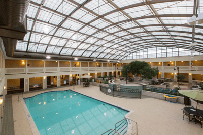Indoor swimming pool area with a glass roof