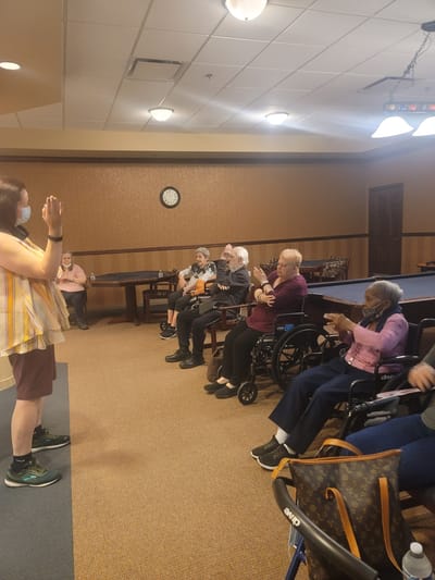 Residents participating in a group activity in a common room