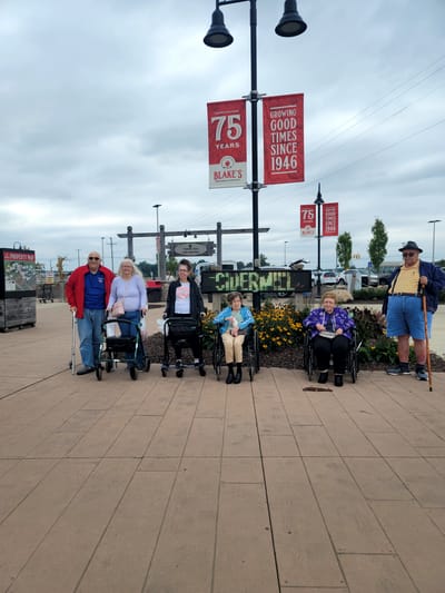 Residents enjoying the outdoor space with flowers and signage