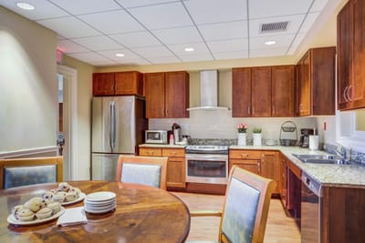 A kitchen area with dining table and baked goods