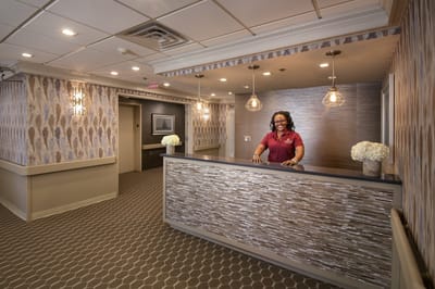 Reception area with a smiling staff member