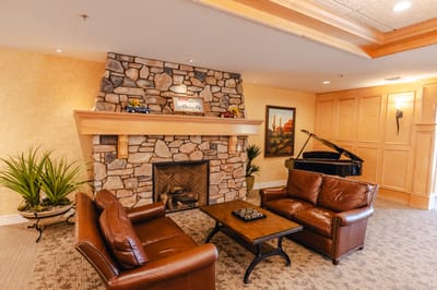 Cozy lounge area with a fireplace and piano