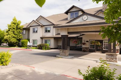 Front entrance of Highgate Senior Living with landscaping and people