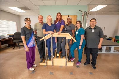 Staff members posing in a therapy room