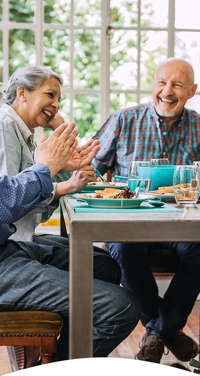 Residents enjoying a meal at a dining table