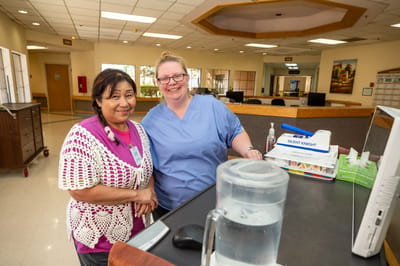 Staff members smiling at the reception desk