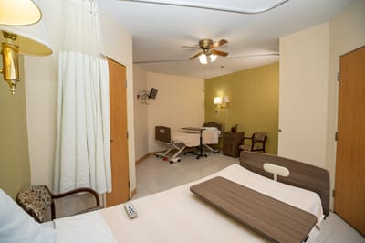 Private resident room with basic furnishings and lighting