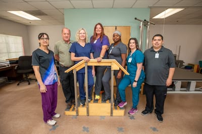 A group of staff posing together inside the facility