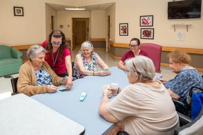 Residents engaging in a card game in a common area
