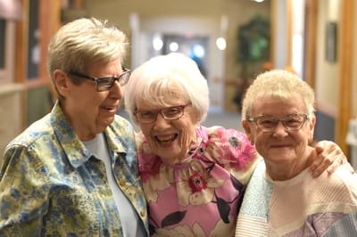 Three smiling residents enjoying time together
