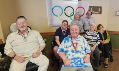 Residents participate in an Olympic-themed activity with medals