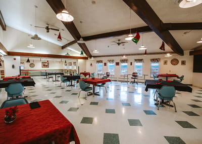 Dining area with tables set for residents' activities