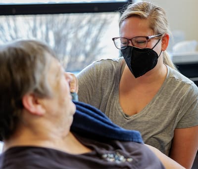 Caregiver assisting a resident in a therapy session