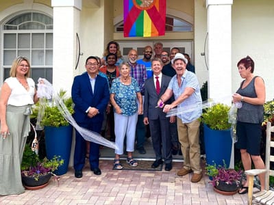 Residents and staff celebrating outside the facility