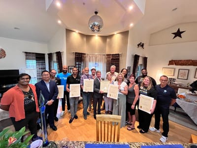 Group of people celebrating in a warm, inviting common area