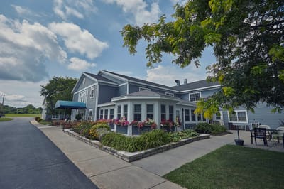Exterior view of a senior living facility with gardens