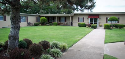 Exterior view of Cedarcrest Care Center with manicured lawn