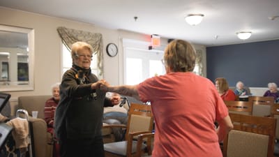 Residents dancing together in a common area