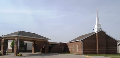 Exterior view of a facility with a steeple and entrance
