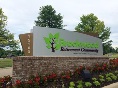 Sign for Brookwood Retirement Community with logo